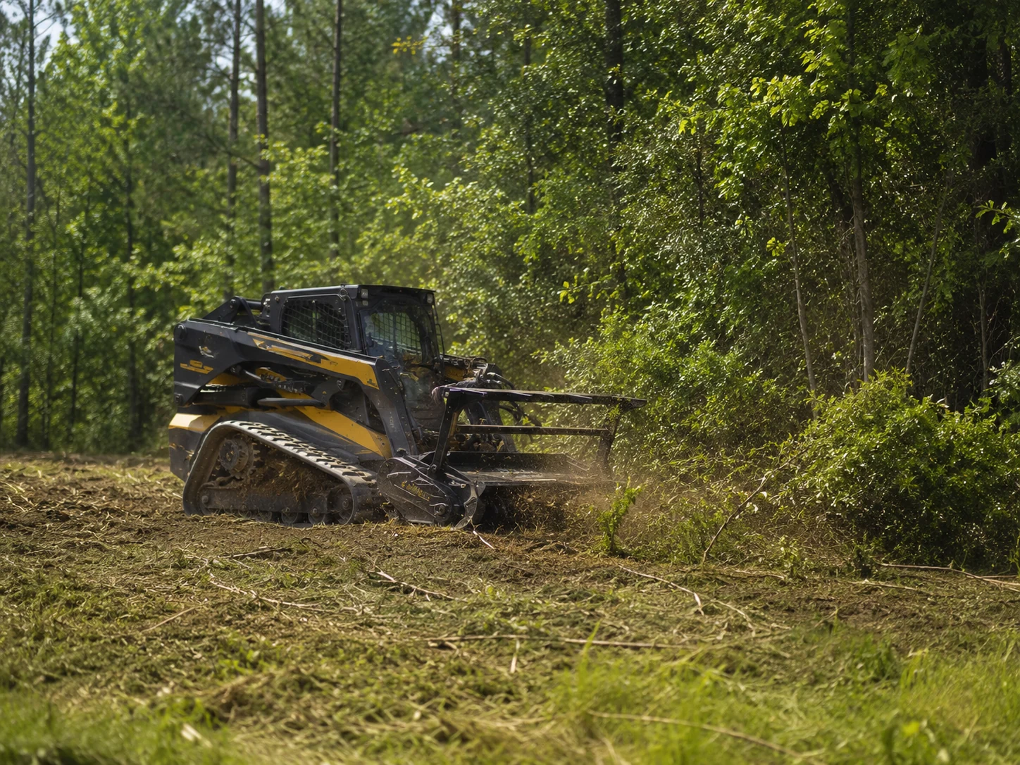Skid steer clearing brush